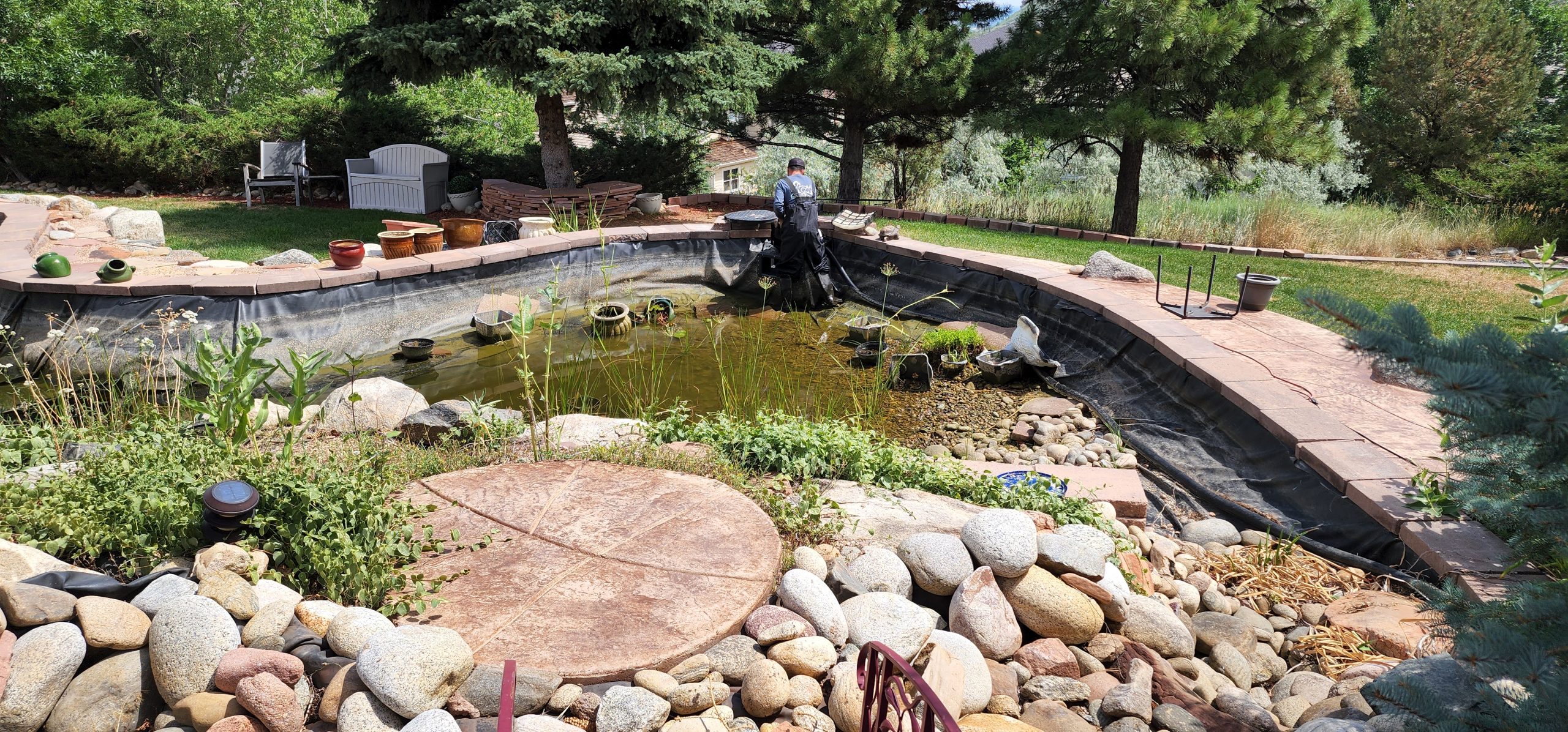 A man cleaning a pond in Colorado
